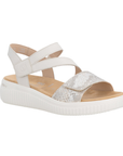 White backstrap sandal with Velcro split strap, snake print strap, tan Remonte logo'd footbed, and thick ribbed white outsole.