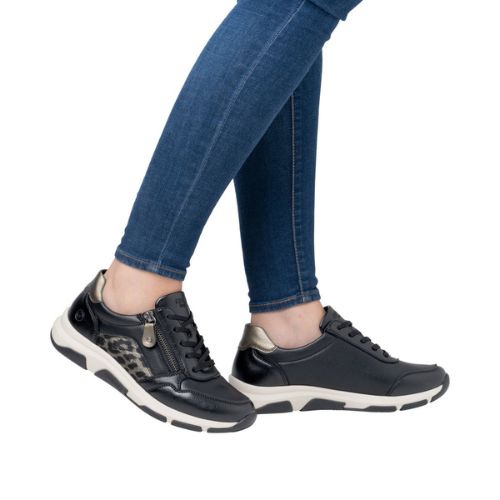 Model wearing Women's Remonte D1S01 lace-up sneakers with jeans, highlighting stylish fit, comfort, and easy-access side zipper.