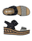 Pair of Black wedge sandals with a checkered toe band strap, faux buckle on top Velcro strap and a faux cork wedge midsole with black accent lines.