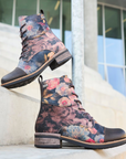 Floral patterned combat boots with blurred steps to a building in background.