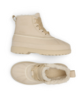 Pair of Tan ankle boots with thick rubber outsole, thick decorative laces and faux fur poking out of top.