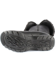 Black treaded outsole of tall boot on its side with inside zipper and folded down cuff.