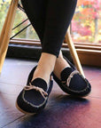 Model with crossed legs wearing the Ottawa Moccasin in Navy.