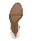 Tan light treaded outsole of kitten heel with Naturalizer logo stamped in middle.