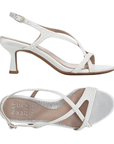 Pair of White kitten heels with thin criss-crossing pearl lined straps, buckle closure, and tan Naturalizer logo'd footbed.