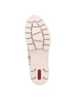 Treaded white outsole of Chelsea boot with red Rieker logo on heel.