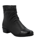 Black leather ankle boot with gathering at instep, black patent toe cap and low heel.