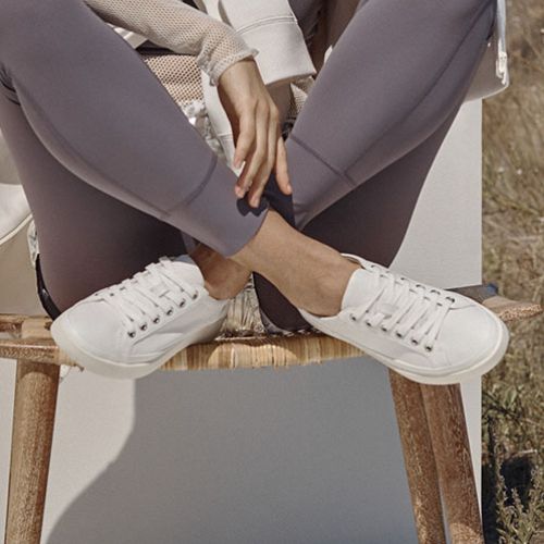 Lifestyle image of Winny Sneaker - Leather Lace-Up in white worn outdoors. Combines comfort and style for casual wear.