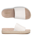Pair of white slide espadrille sandals with Vionic logo'd tan footbed.