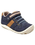 Leather sneaker in navy with brown accents, elastic laces and hook-and-loop strap and white outsole.