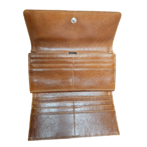 Tan leather interior of dark brown tri-fold clutch wallet.