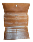 Tan leather interior of dark brown tri-fold clutch wallet.
