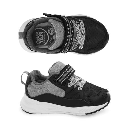 Black and gray kids’ sneakers with white soles, velcro straps, and a memory foam footbed, shown from top and side views.