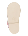 Beige outsole with minimal tread and Stride Rite logo stamped on middle.