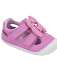 A pink toddler sandal with two hook-and-loop straps, a large matching bow on the toe and white soft bottom outsole.