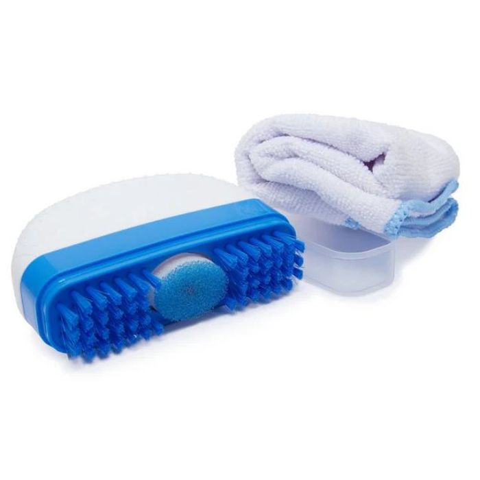 White and blue shoe brush with bristles and sponge applicator beside white microfiber cloth.