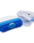 White and blue shoe brush with bristles and sponge applicator beside white microfiber cloth.