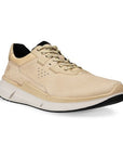 An Ecco light beige leather sneaker with black accents in beige laces. Lining is black. Midsole is white, outsole is black.