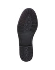 Black geometric treaded outsole on ankle boot.
