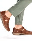 Brown leather Fisherman Sandal worn with sage green pants.