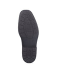 Black rubber outsole of dress boot with Rieker logo on heel.