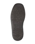 Black rubber outsole with arrow patterned tread.