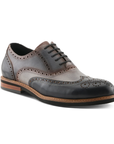 Gray, navy and black oxford wingtip brogue shoe with laces, burnished finish, tan midsole and black outsole.
