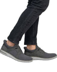 Model wearing Men's grey slip on Sneakers and black jeans.