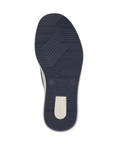 Outsole of slip-on sneaker with light textured navy rubber and white Rieker logo on heel.