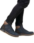 Person in dark jeans and blue high-top sneakers with tan accents.
