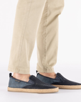 Navy mesh loafers worn with beige pants.