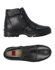 Pair of Black leather slip-on boots with side zippers, accent stitching and fur lining.