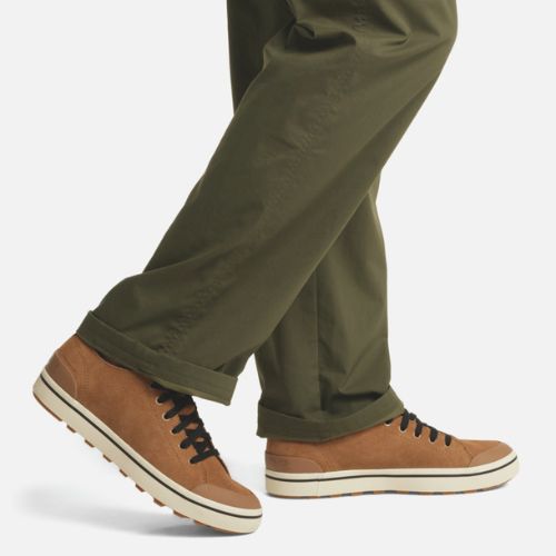 Model wearing Men's Sorel Metro II Low Sneaker with olive pants, highlighting the casual waterproof style for everyday wear.