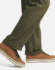 Model wearing Men's Sorel Metro II Low Sneaker with olive pants, highlighting the casual waterproof style for everyday wear.