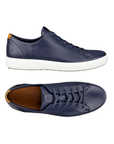 Pair of Navy blue sneakers with navy laces, tan leather ecco logo'd footbed, white midsole and beige outsole.