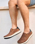 Men's Rieker 16952 Slip-On Sneakers styled with shorts, highlighting breathable perforated upper and relaxed summer-ready look.