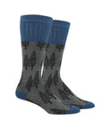 Grey mid-calf socks with black fir tree pattern and navy blue cuff, heel and toe.