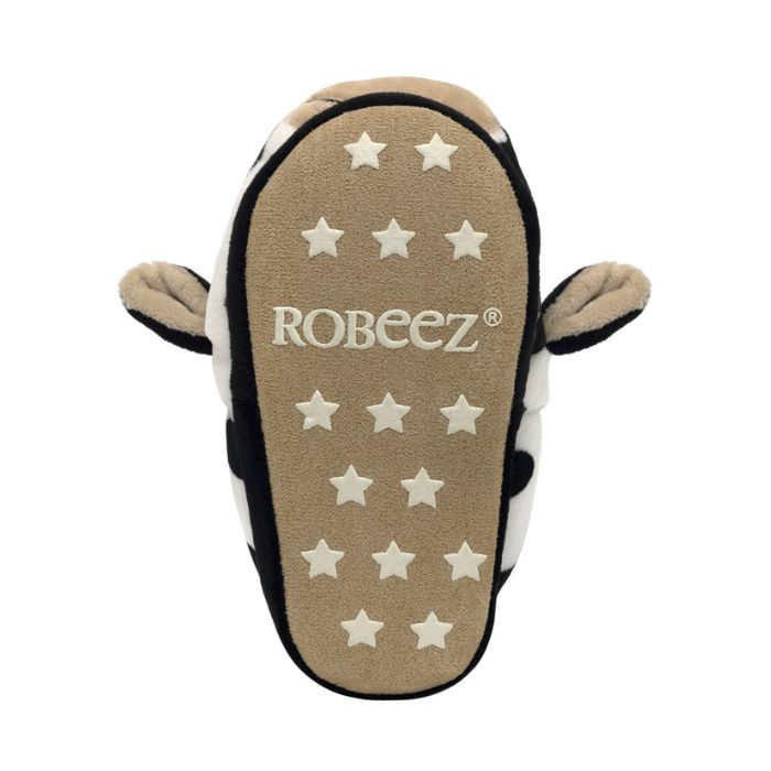 Beige outsole of cow slipper with star grip pattern and Robeez logo in middle.
