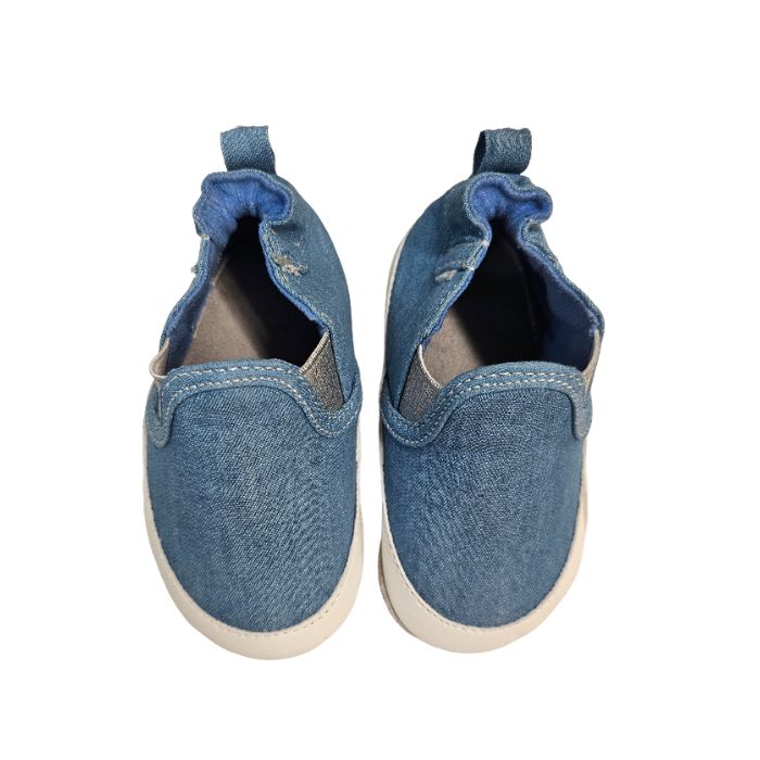 A pair of blue denim baby shoes with white midsole and grey suede outsoles.