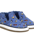 Blue canvas baby's shoes with vehicle pattern, white midsole and tan suede outsole.