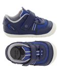 Pair of Navy and blue toddler shoes with Velcro strap, grey accents, Stride rite logo'd footbed and white soft motion outsole.