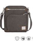 Pewter grey canvas crossbody locking strap bag with two locking front zipper pockets, Travelon logo in corner, anti-theft feature icons across bottom.