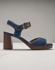 Side profile of Clarks AmbyrLyn Faye women's denim sling-back sandal with stacked block heel and gold buckle for elevated style.