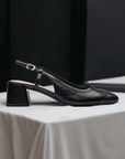 Clarks Nyta45 women's stylish leather pump displayed on a table, highlighting its elegant design and versatile black finish.