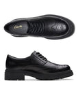 Pair of black leather derby lace shoes with a chunky rubber outsole and intricate baroque details.