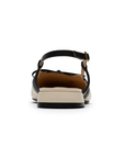 Heel of Pointed-toe slingback flat with black bow detail, cream upper and a low block heel.