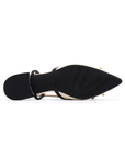 Black light treaded outsole of pointed toe shoe with low block heel.