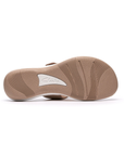 Beige outsole with light wave pattern tread and white Clarks logo in middle.
