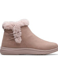 A mauve ankle boot with faux fur trim and a mauve outsole.