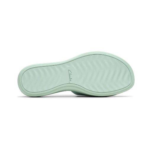 Bottom view of mint green Clarks Drift Twist Slide Sandals with wave-patterned outsole for traction and comfort in women's flat slides.